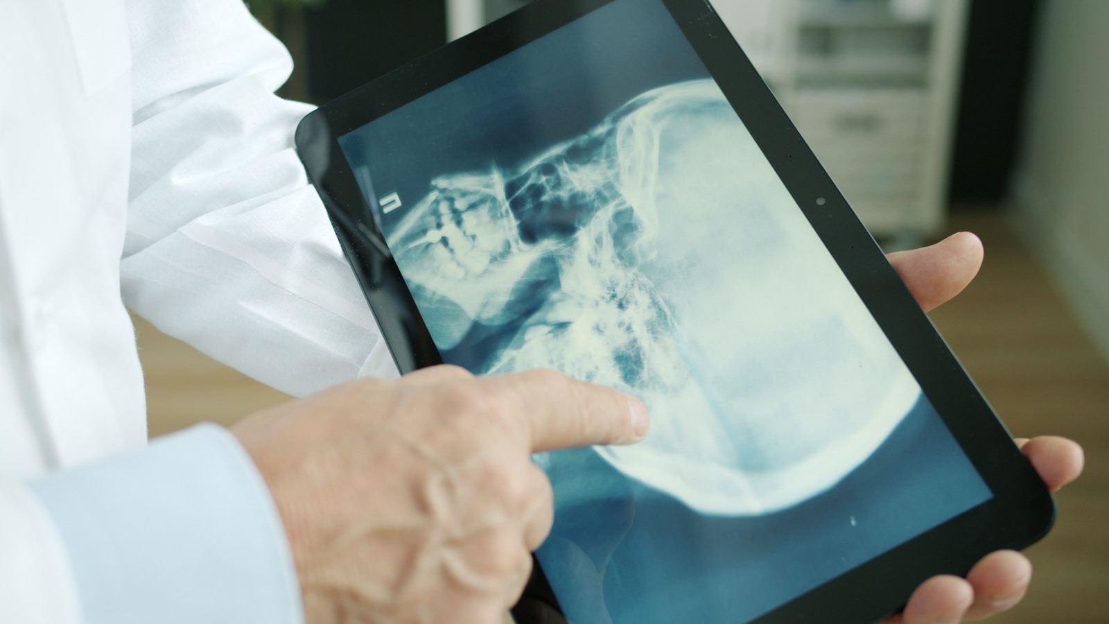 Physician reviewing an X-ray on a tablet